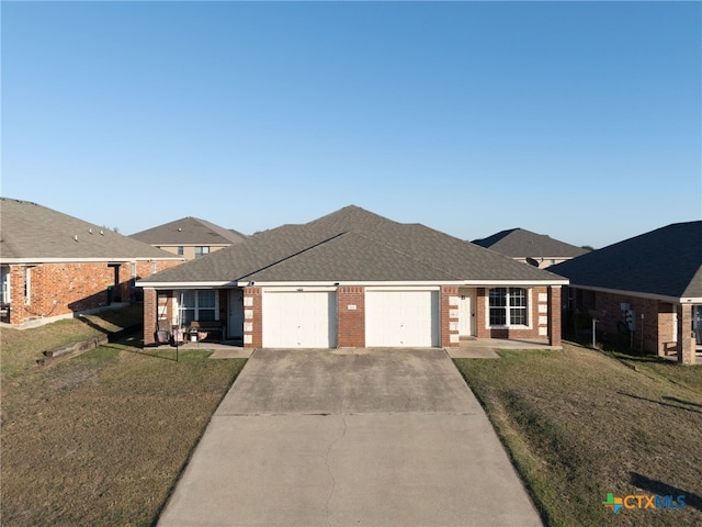 ranch-style home featuring a garage and a front lawn