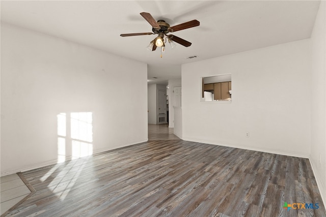 empty room featuring ceiling fan and hardwood / wood-style floors