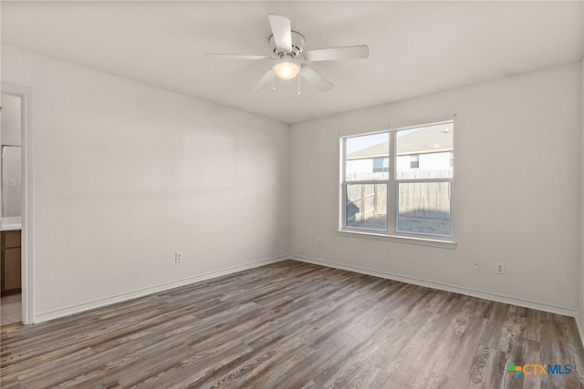 empty room featuring ceiling fan and wood-type flooring