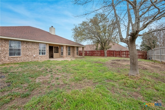 view of yard with a fenced backyard and a patio