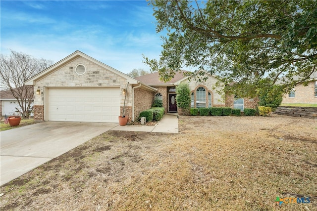 single story home with a garage, brick siding, and driveway