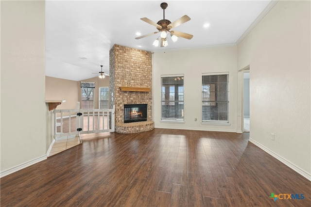 unfurnished living room with ceiling fan, a fireplace, baseboards, and wood finished floors