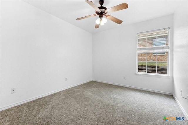 unfurnished room featuring carpet, baseboards, and ceiling fan