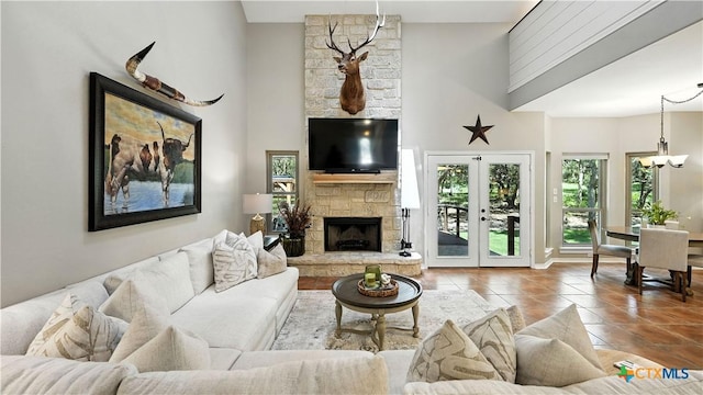 405 Pinnacle Pkwy, New Braunfels, TX 78132 - living room featuring tile patterned flooring, a stone fireplace, and a chandelier