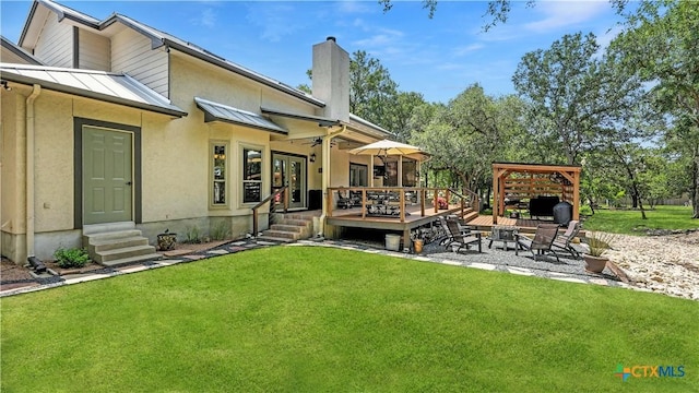405 Pinnacle Pkwy, New Braunfels, TX 78132 - rear view of house featuring a standing seam roof, entry steps, a yard, a wooden deck, and a chimney