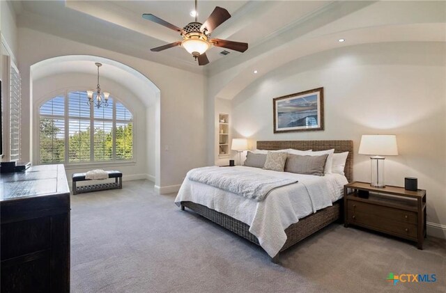 124 Schooner Dr, Lakeway, TX 78738 - bedroom with carpet floors, a chandelier, arched walkways, a tray ceiling, and recessed lighting