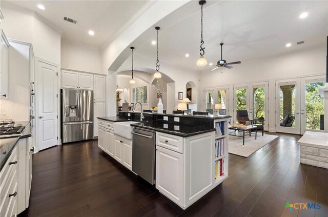 124 Schooner Dr, Lakeway, TX 78738 - kitchen featuring appliances with stainless steel finishes, a ceiling fan, arched walkways, recessed lighting, and dark countertops