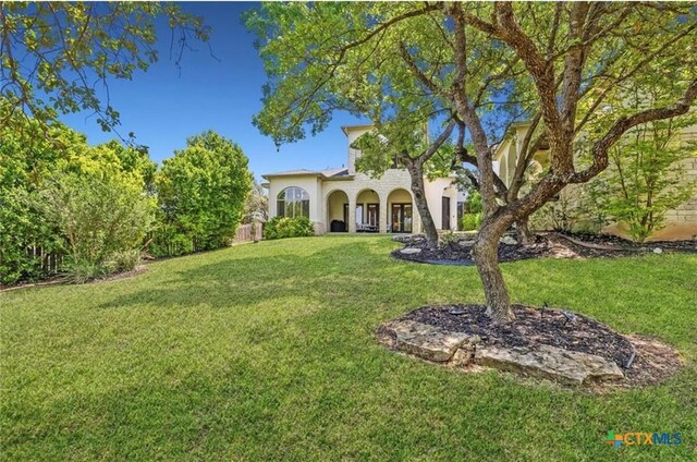 124 Schooner Dr, Lakeway, TX 78738 - mediterranean / spanish-style house featuring a front yard and stucco siding
