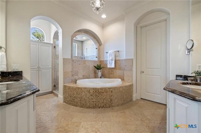 124 Schooner Dr, Lakeway, TX 78738 - bathroom featuring crown molding, two vanities, a bath, and a stall shower