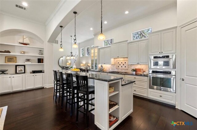 124 Schooner Dr, Lakeway, TX 78738 - kitchen featuring open shelves, ornamental molding, dark countertops, double oven, and dark wood-style flooring