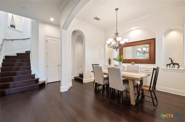 124 Schooner Dr, Lakeway, TX 78738 - dining room with stairway, arched walkways, dark wood-style flooring, ornamental molding, and a chandelier