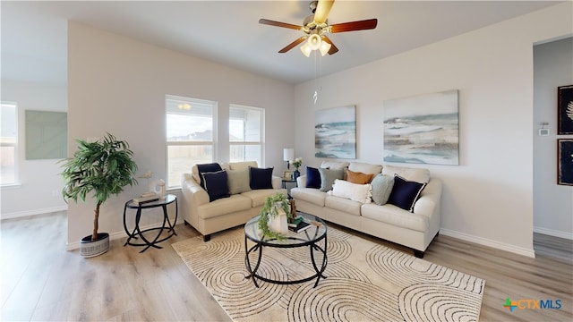 living room featuring ceiling fan and light hardwood / wood-style flooring