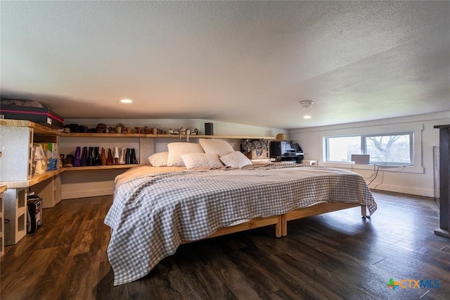 3270 Fm 671, Luling, TX 78648 - bedroom featuring a textured ceiling, wood finished floors, and a wood stove