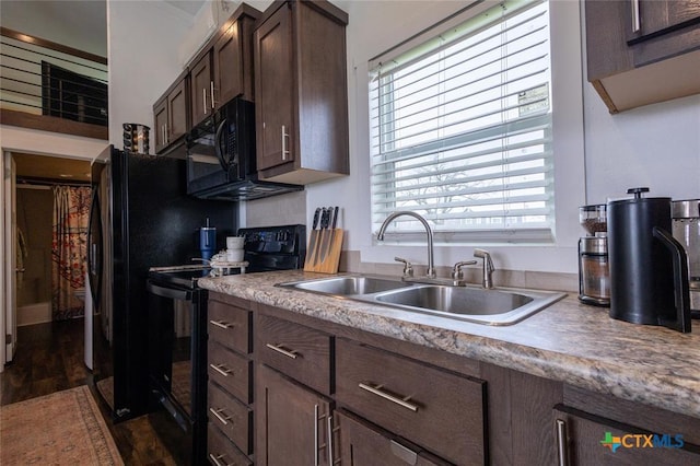 3270 Fm 671, Luling, TX 78648 - kitchen featuring dark brown cabinetry, dark wood-style floors, light countertops, black appliances, and a sink