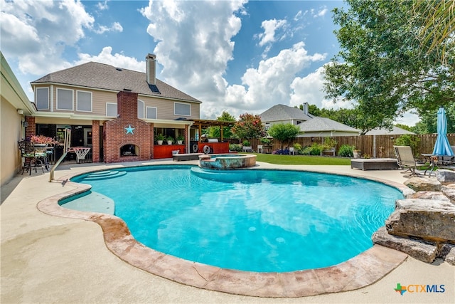 view of pool featuring a patio area and an in ground hot tub