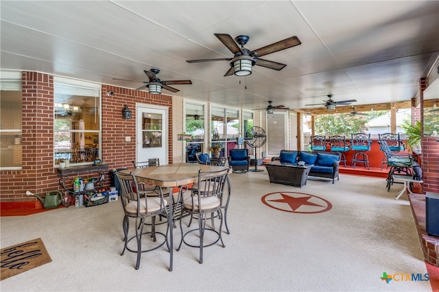 view of patio with an outdoor living space and ceiling fan