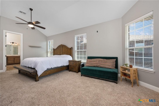 bedroom with multiple windows, visible vents, vaulted ceiling, and carpet