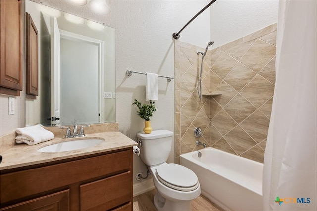 full bath featuring toilet, wood finished floors, vanity, and shower / tub combo with curtain
