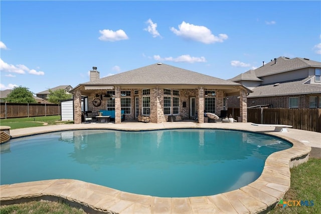view of pool with a diving board, a patio, a fenced in pool, and a fenced backyard