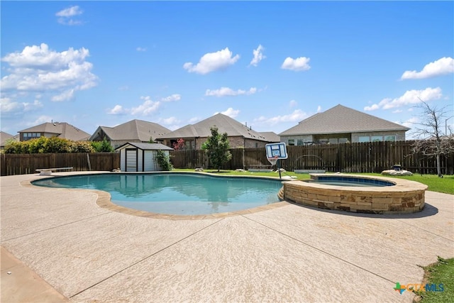view of pool with a patio, an outbuilding, a storage shed, a fenced backyard, and a pool with connected hot tub