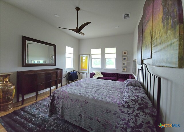 bedroom featuring visible vents, ceiling fan, and wood finished floors