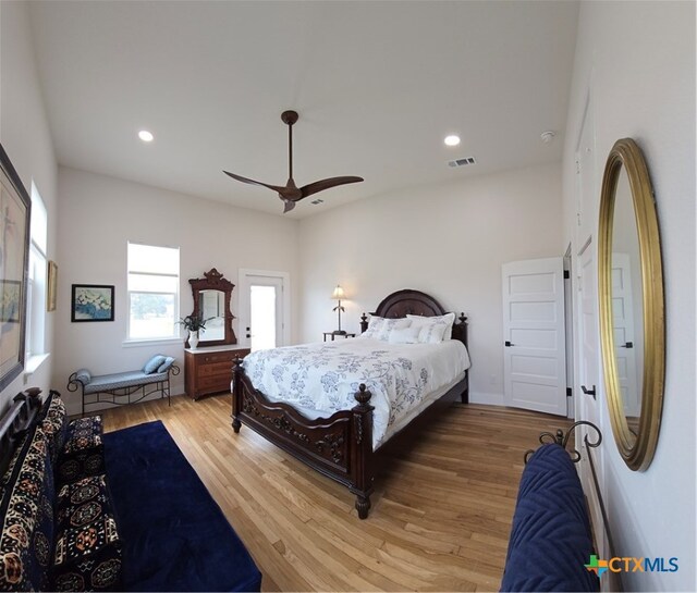 bedroom with ceiling fan, wood finished floors, visible vents, and recessed lighting