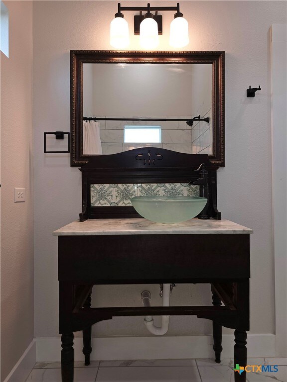 bathroom featuring vanity and baseboards