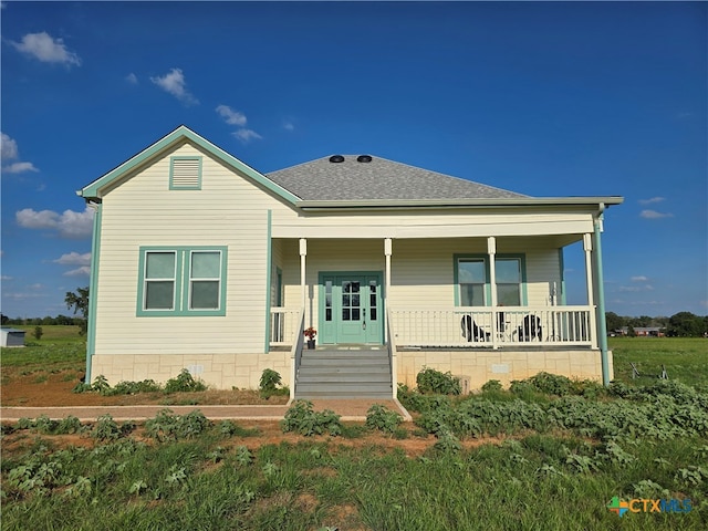 view of front of house with a shingled roof and a porch