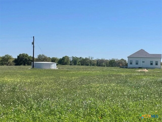 view of yard with a rural view