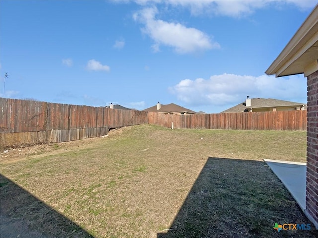 view of yard with a fenced backyard