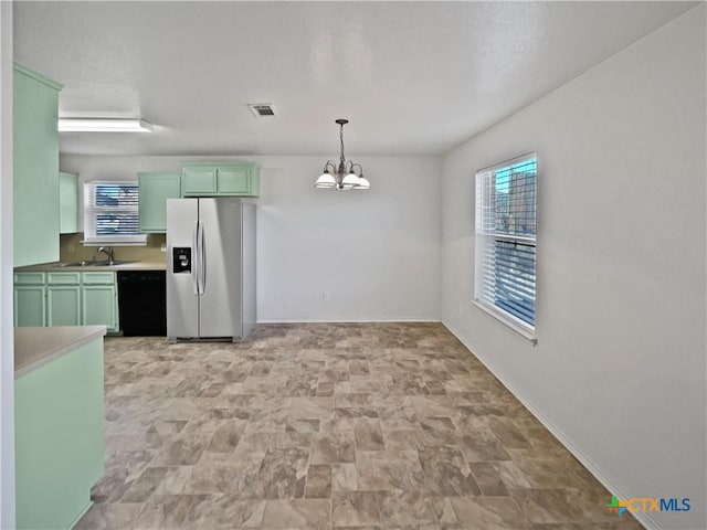 kitchen featuring green cabinetry, a sink, stainless steel refrigerator with ice dispenser, and black dishwasher