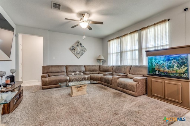 carpeted living room with ceiling fan