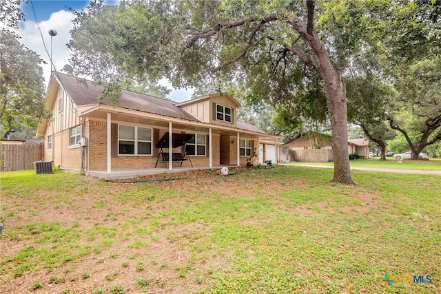 view of front of home featuring a front lawn and central AC unit