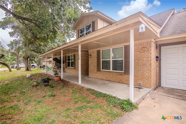 view of front facade with a porch and a garage