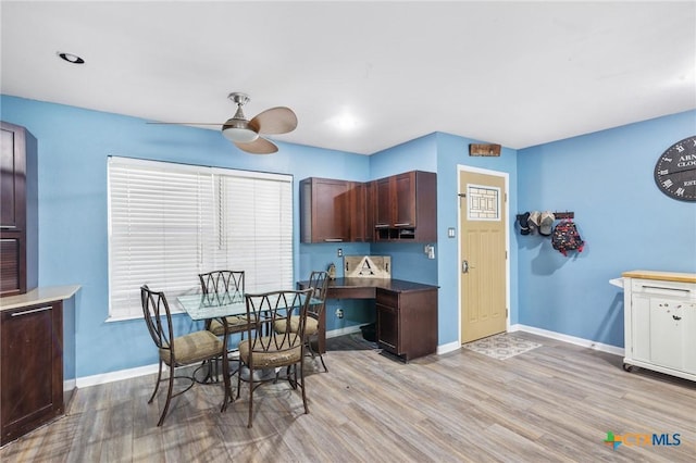 dining room with ceiling fan and light hardwood / wood-style floors