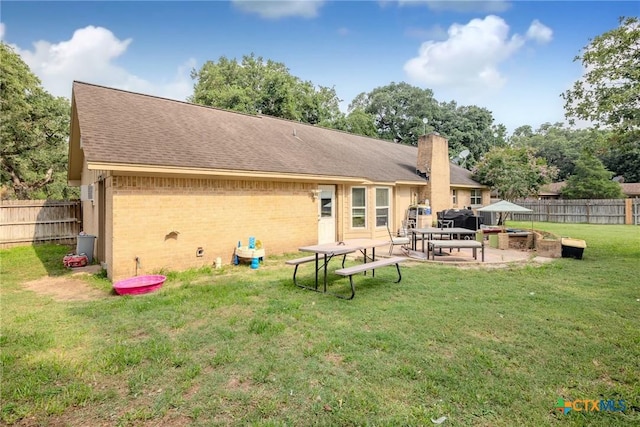 back of house featuring a yard and a patio area