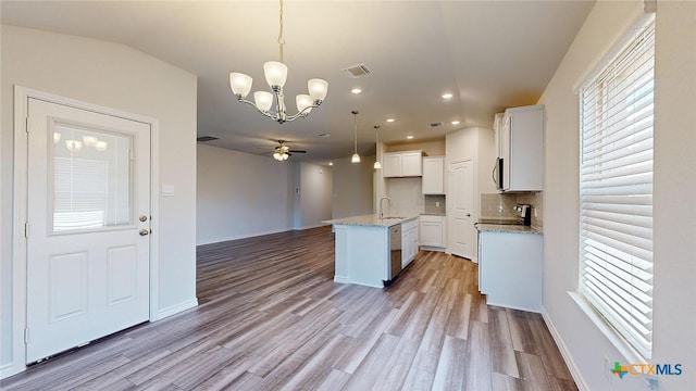 4024 Hayes Ct, Belton, TX 76513 - kitchen with open floor plan, a sink, a chandelier, light wood-style flooring, and a ceiling fan