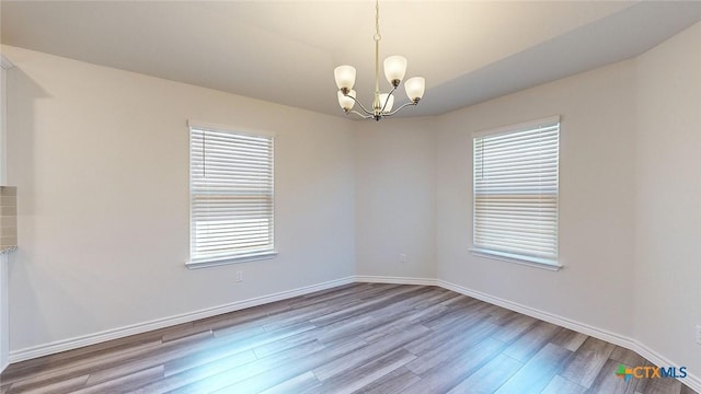 4024 Hayes Ct, Belton, TX 76513 - empty room featuring wood finished floors, a chandelier, and baseboards