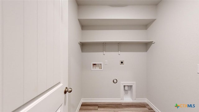 4024 Hayes Ct, Belton, TX 76513 - laundry area featuring electric dryer hookup, washer hookup, wood finished floors, baseboards, and hookup for a gas dryer
