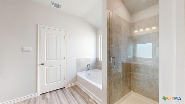 4024 Hayes Ct, Belton, TX 76513 - full bath with a bath, a shower stall, vaulted ceiling, wood finished floors, and baseboards