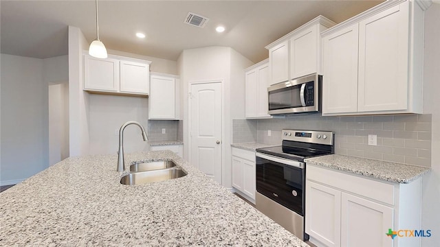 4024 Hayes Ct, Belton, TX 76513 - kitchen with appliances with stainless steel finishes, a sink, white cabinetry, tasteful backsplash, and recessed lighting
