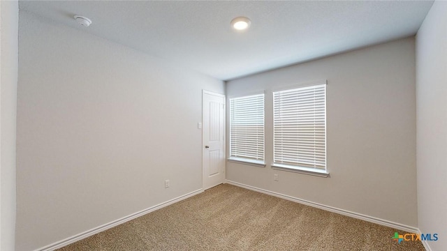 4024 Hayes Ct, Belton, TX 76513 - carpeted spare room with baseboards and a smoke detector