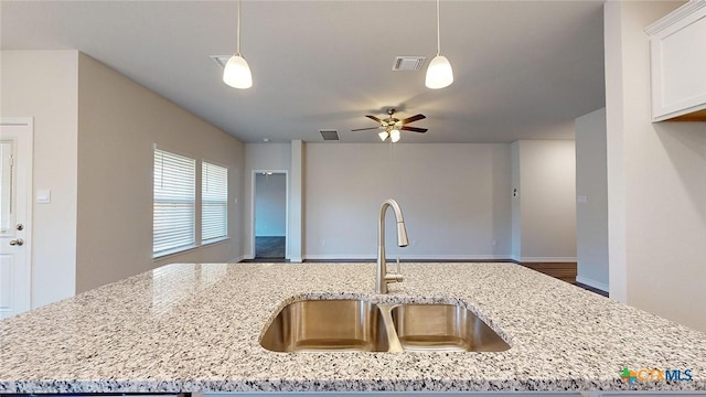 4024 Hayes Ct, Belton, TX 76513 - kitchen with a sink, open floor plan, light stone countertops, and hanging light fixtures