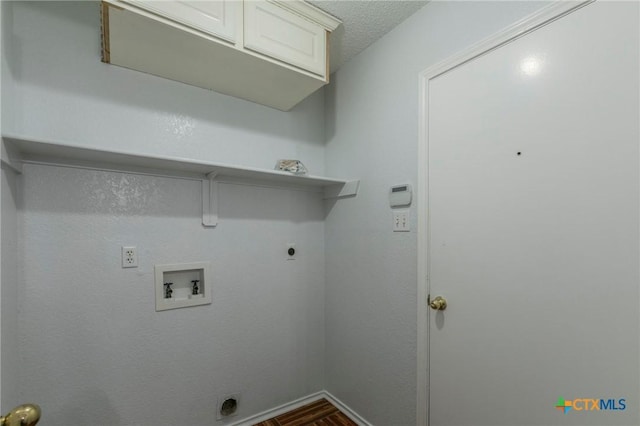 washroom with cabinet space, baseboards, hookup for a washing machine, a textured ceiling, and electric dryer hookup