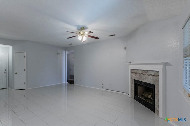 unfurnished living room featuring a fireplace, visible vents, ceiling fan, a textured ceiling, and baseboards