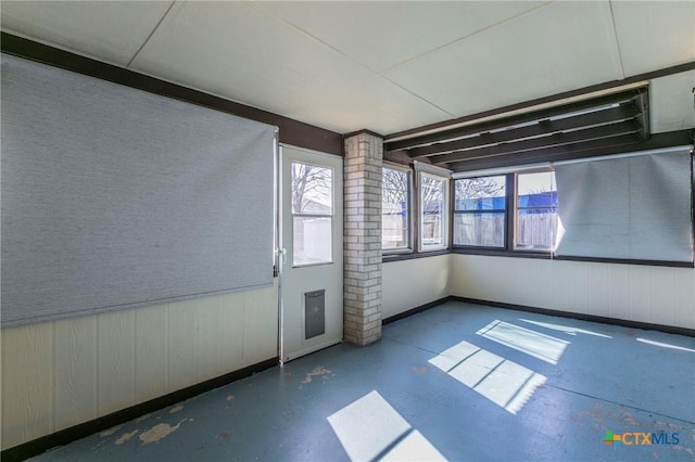 interior space with finished concrete floors and wainscoting