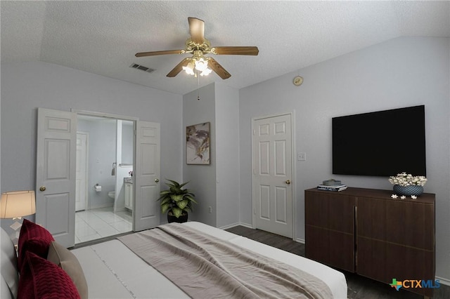 bedroom featuring lofted ceiling, visible vents, ceiling fan, and a textured ceiling