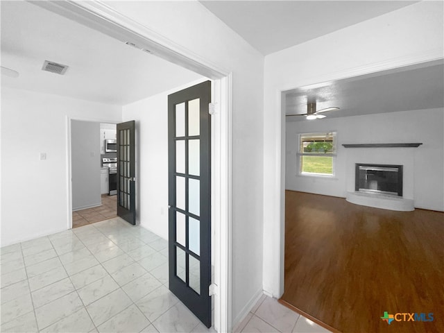 corridor with light hardwood / wood-style flooring