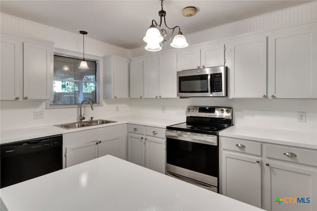 kitchen with stainless steel appliances, hanging light fixtures, sink, a notable chandelier, and white cabinetry