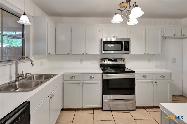 kitchen featuring white cabinetry, stainless steel appliances, sink, and decorative light fixtures